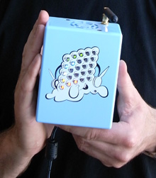 A photograph of hands holding the real-world Pufftron sensor.