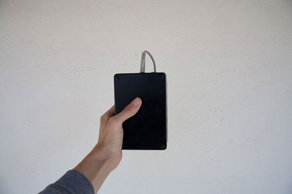 Photograph of the mobile everydatum sensor, showing an Arduino board connected to a Motorola phone.